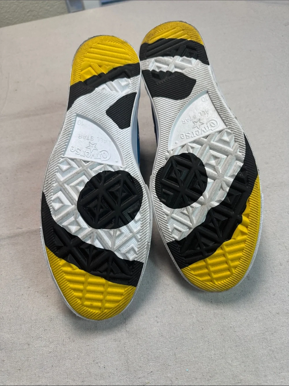 Converse All Star Chuck Golf Wang High Top Sneakers in Yellow, Blue, and Red.